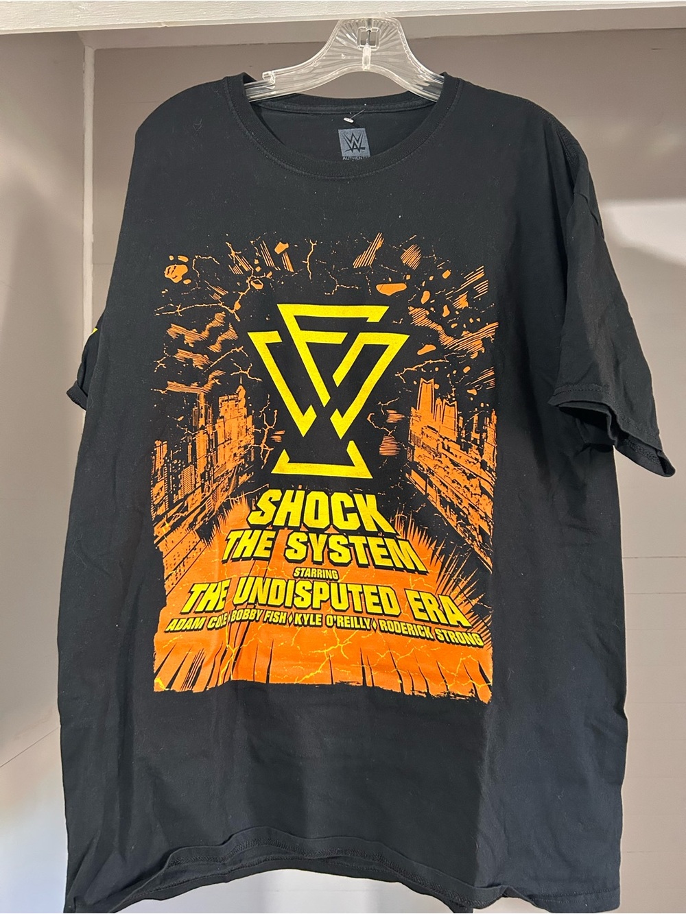 WWE Black T-Shirt with Yellow and Orange 'Shock The System' Graphic